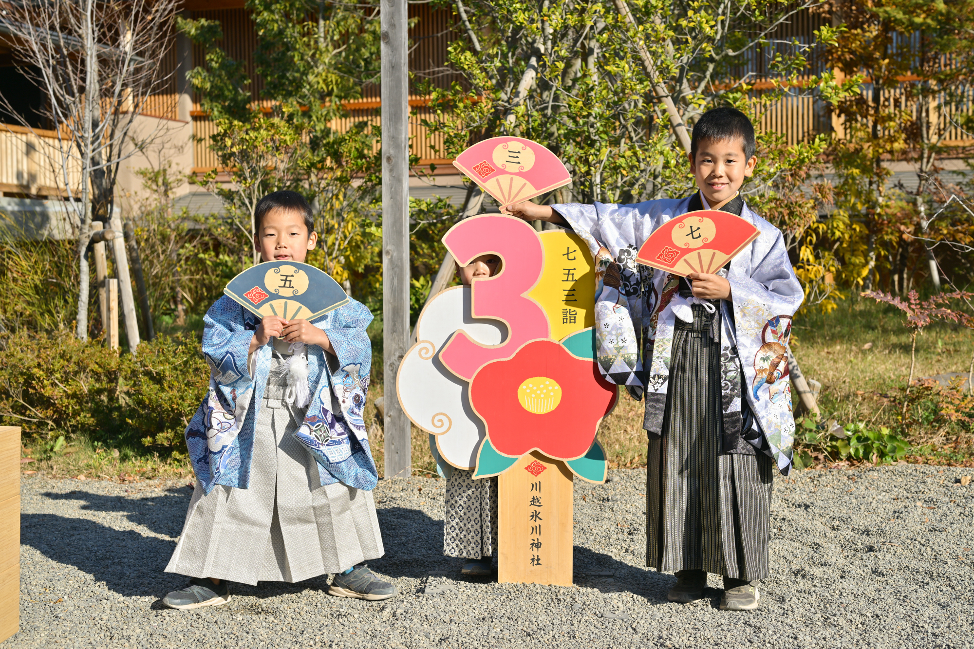 画像 川越氷川神社の七五三限定パネルを背景にそれぞれの成長を祝う3人の子供